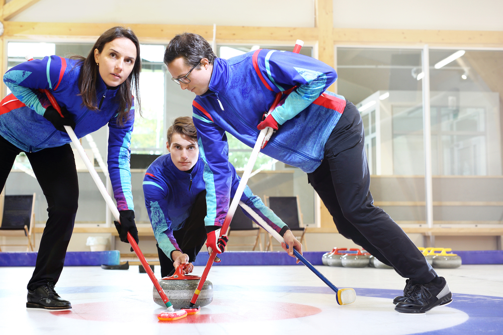 Why do curlers sweep the ice?