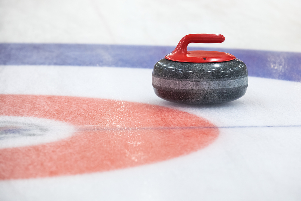 Why do curlers spin the stone before throwing?
